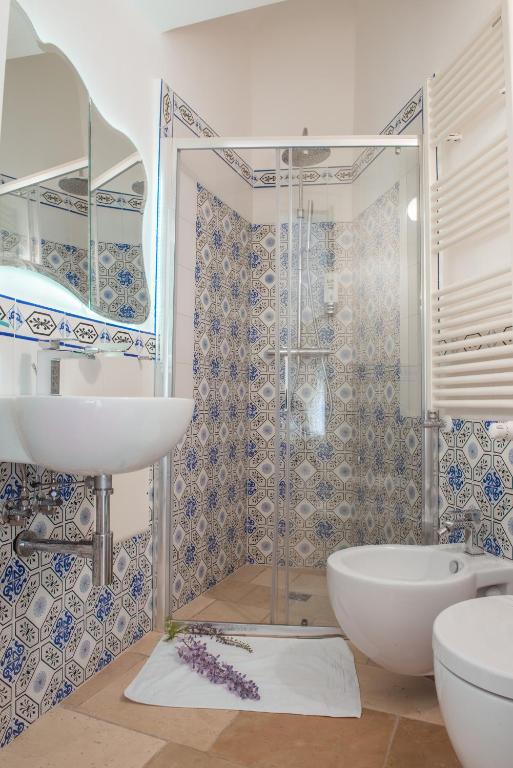 a bathroom with a tub and a sink and a shower at Dimora Dell'Osanna in Carovigno