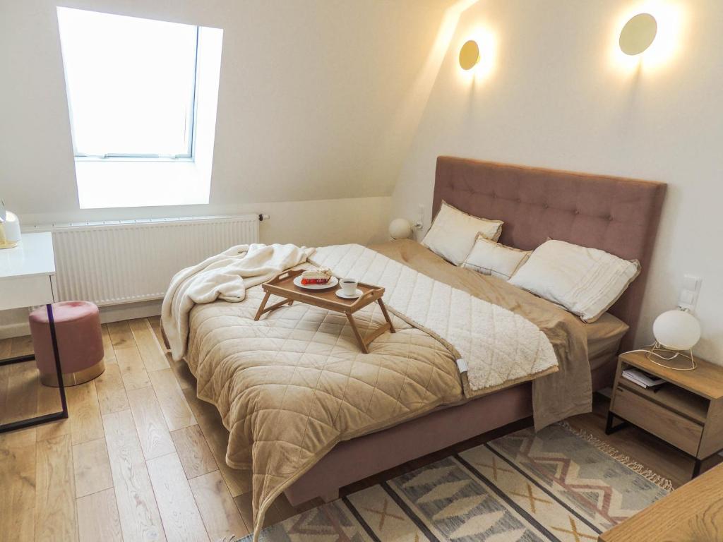a bedroom with a large bed with a table on it at Apartament w centrum Rzeszowa - Grodzisko in Rzeszów