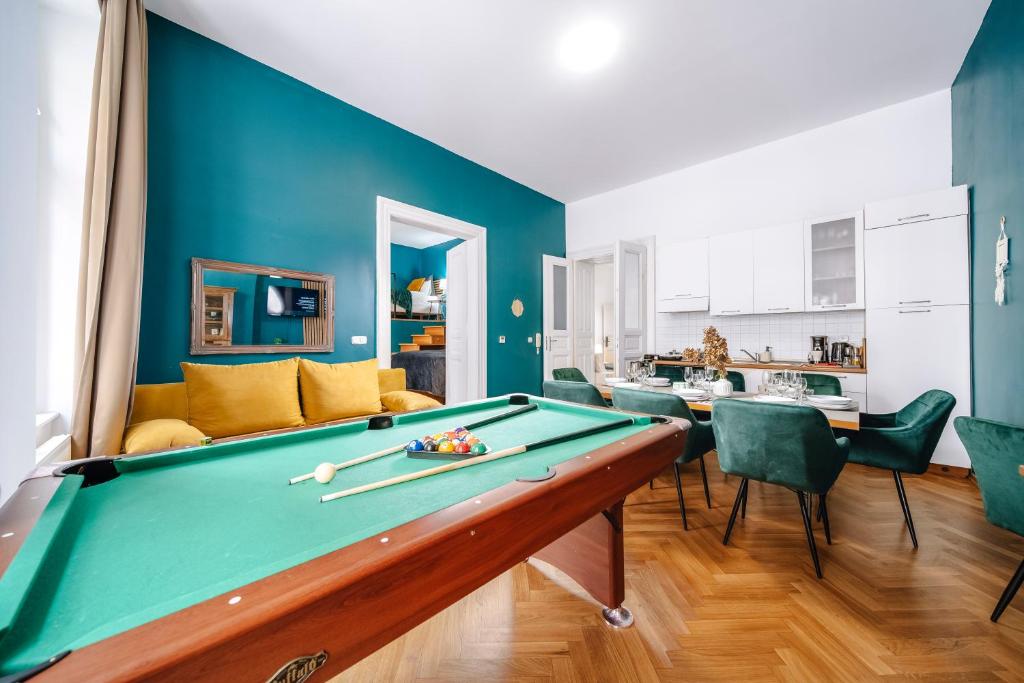 a pool table in a living room with blue walls at Wagnerstays Royal Billiard Residence in Prague
