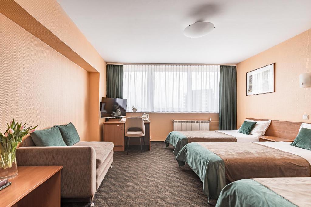 Postel nebo postele na pokoji v ubytování Hotel Zemaites