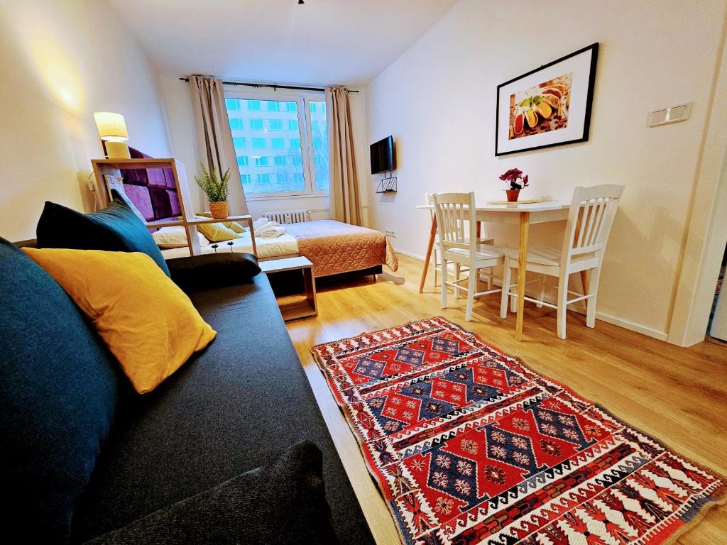 ein Wohnzimmer mit Sofa und Tisch in der Unterkunft LIVE-INN PRAGUE APARTMENTS, Private Garden, Free Parking & Gym, Roof Terrace, Lounge & Game Room in Prag