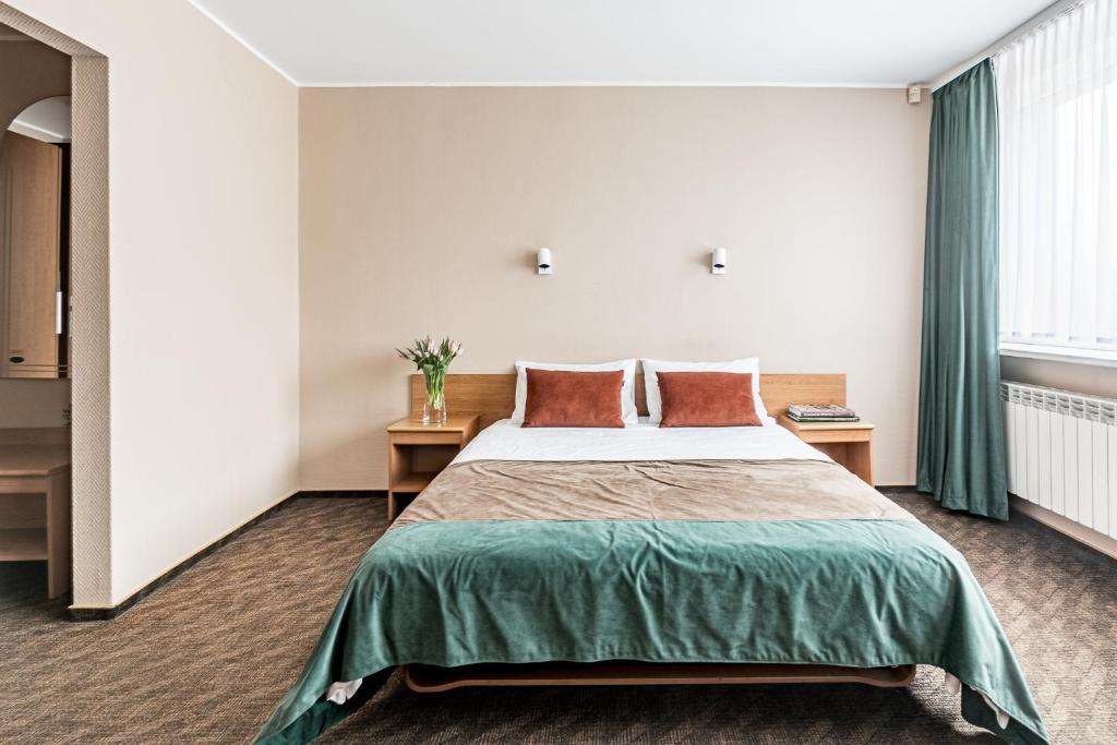 Postel nebo postele na pokoji v ubytování Hotel Zemaites