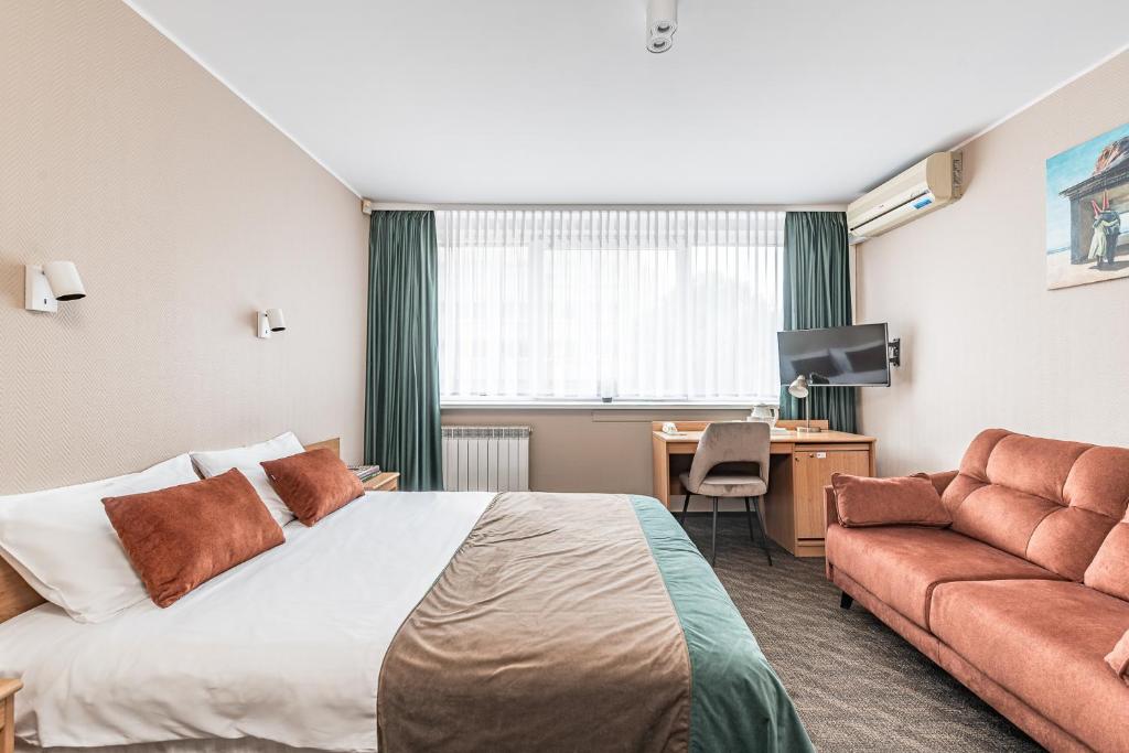 Postel nebo postele na pokoji v ubytování Hotel Zemaites