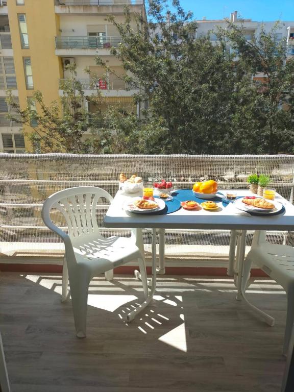 a table with plates of food on it on a balcony at Holiday Spot in Portimão