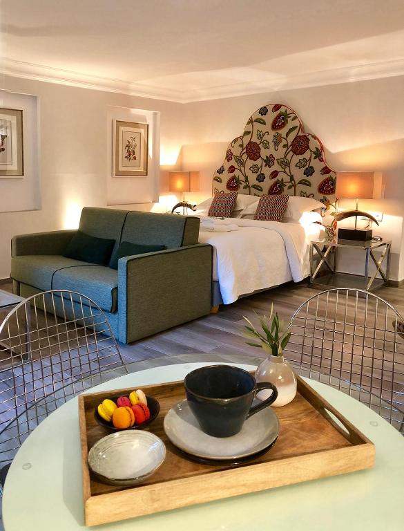 a room with a bed and a tray with a bowl of fruit at Garden Suites in Corfu