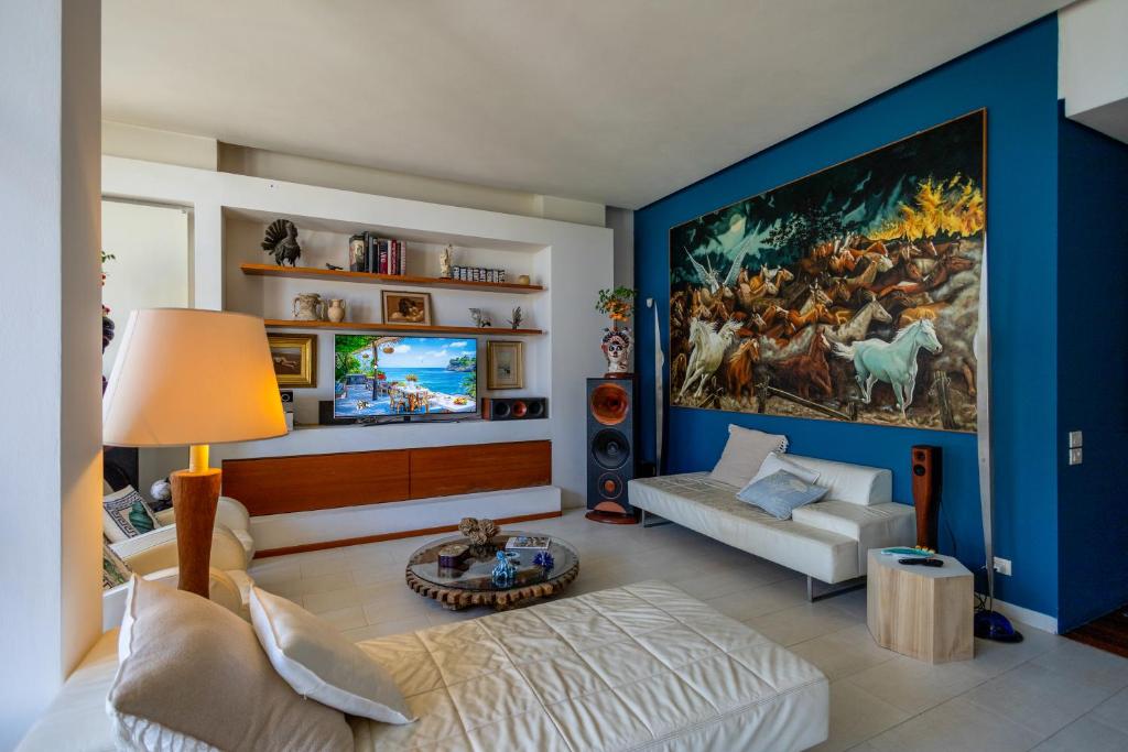 a living room with a large painting on the wall at Villa Olimpia in Mondello