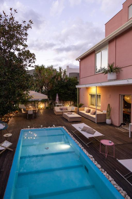 a backyard with a swimming pool and a house at Villa Olimpia in Mondello