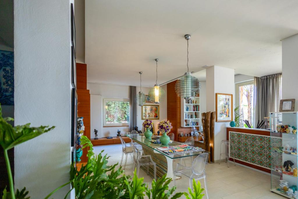 a kitchen and living room with a table and chairs at Villa Olimpia in Mondello