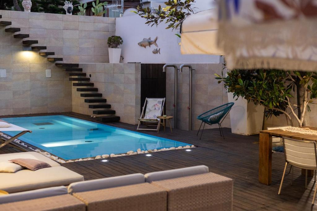 a swimming pool in the middle of a building with a staircase at Villa Olimpia in Mondello