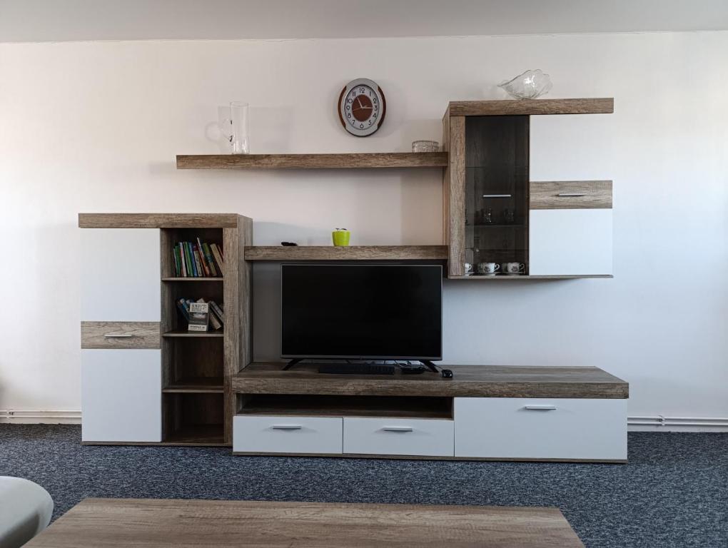a living room with a tv on a white entertainment center at Apartmán Černá v Pošumaví Adam a Eva in Černá v Pošumaví