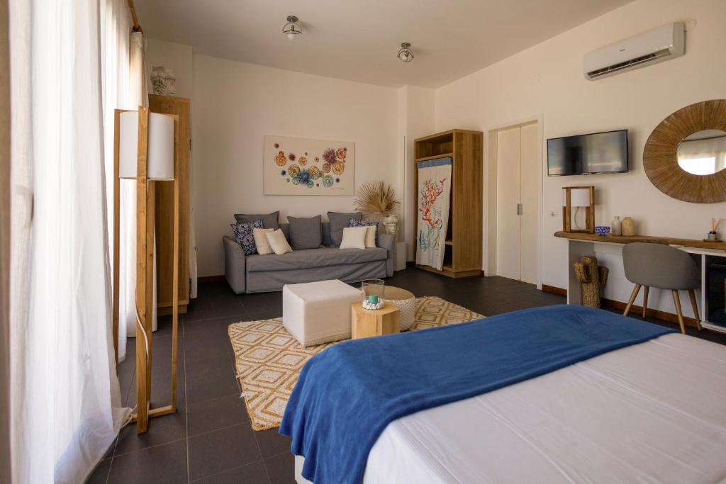 a bedroom with a bed and a living room at Villa Olimpia in Mondello