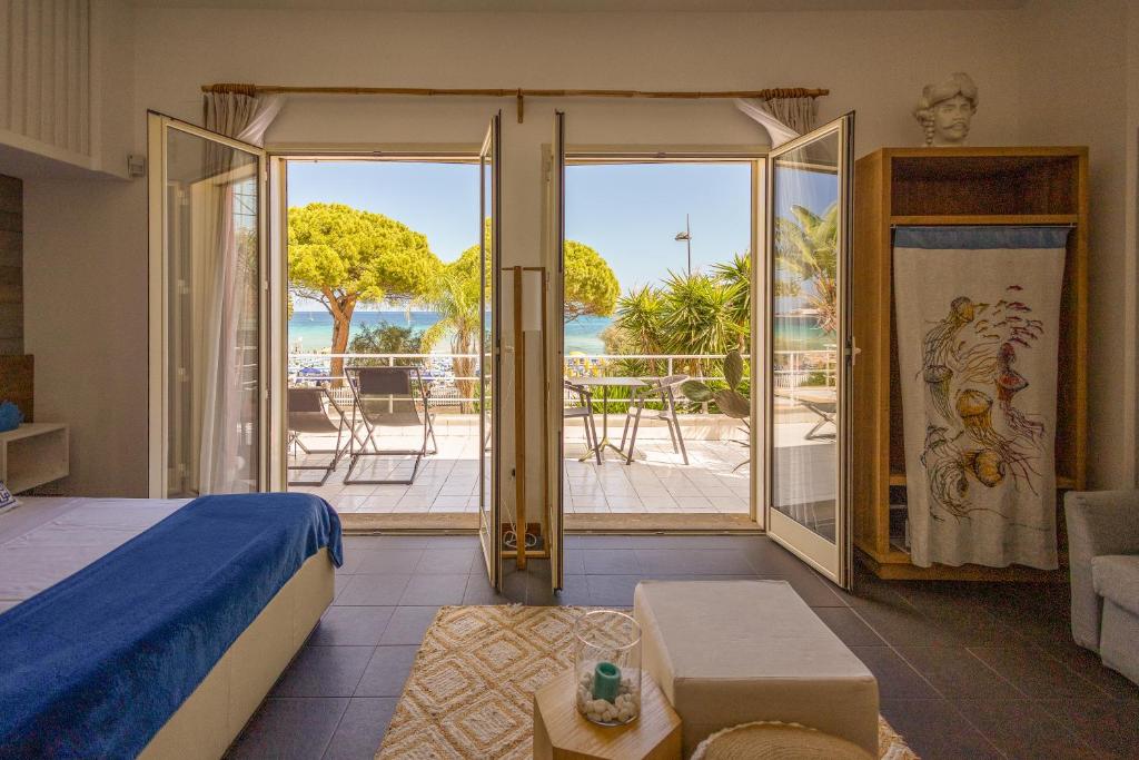 a bedroom with a bed and a view of the ocean at Villa Olimpia in Mondello
