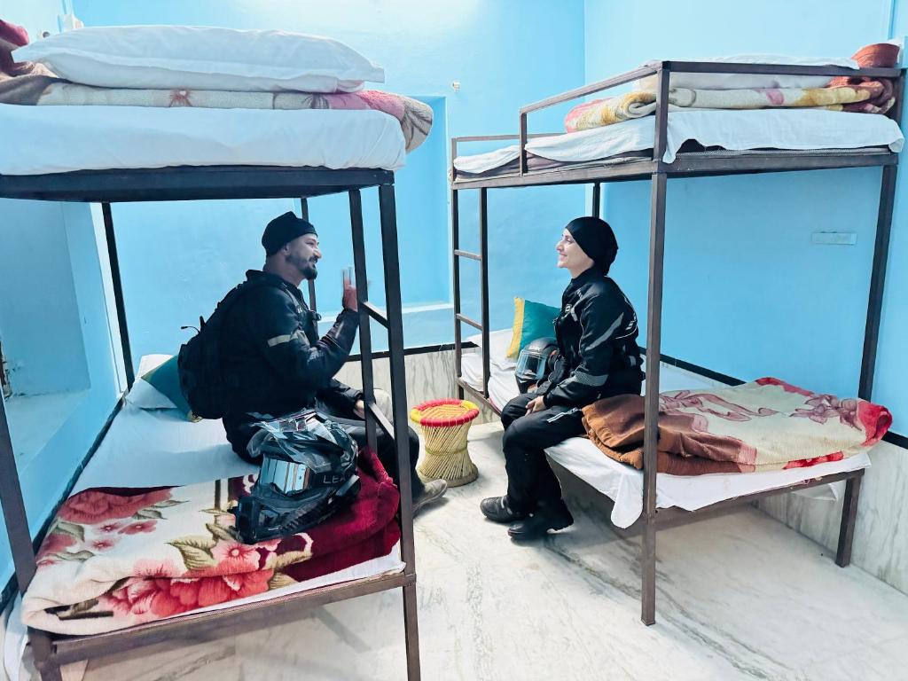 two people sitting on bunk beds on a boat at Happy Trails Jaisalmer in Jaisalmer