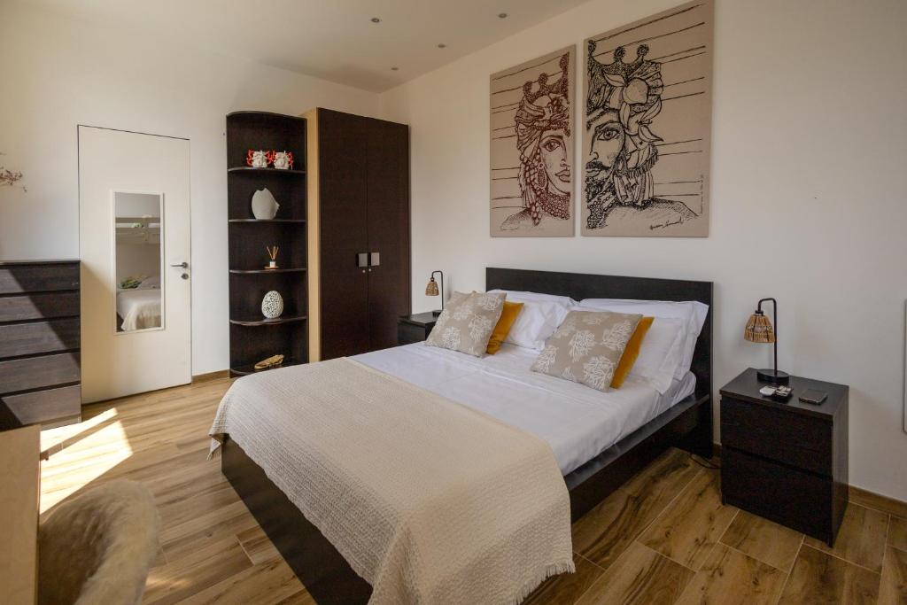 a bedroom with a bed and a chair in it at Villa Olimpia in Mondello