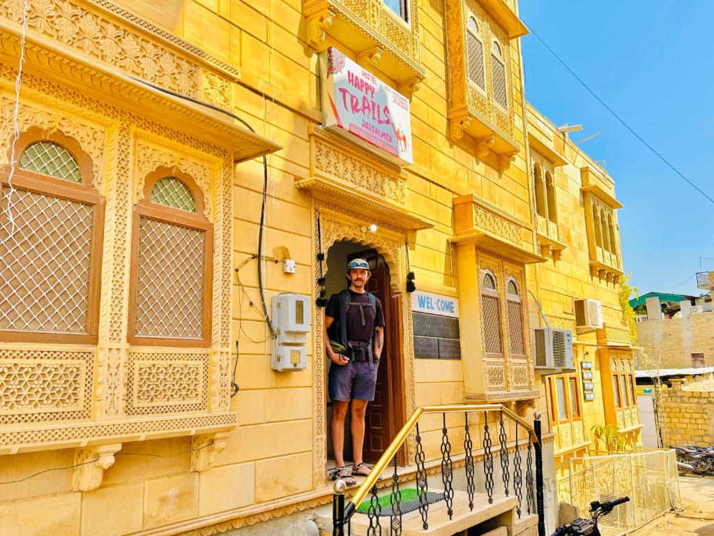 a man standing in the doorway of a building at Happy Trails Jaisalmer in Jaisalmer