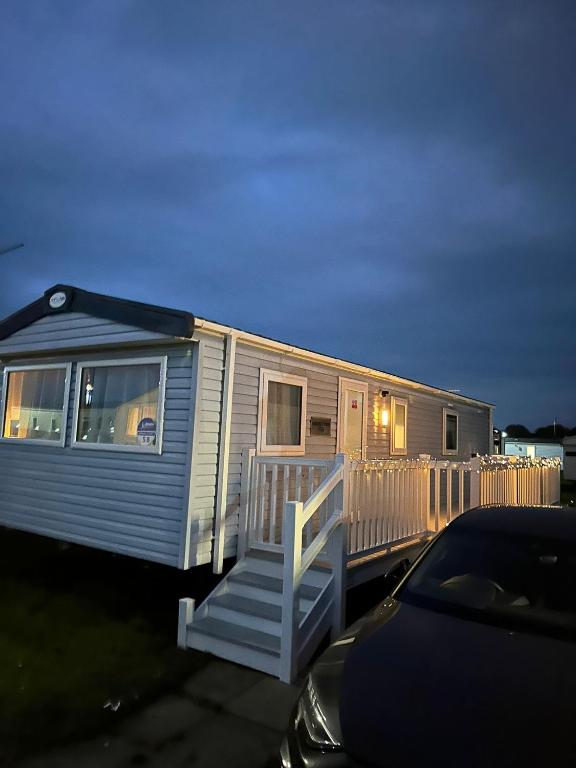 a mobile home with a porch and a staircase at Caravan to Hire - CalaGran Fleetwood Blackpool in Fleetwood
