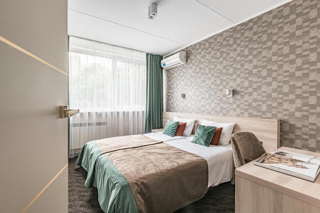 Postel nebo postele na pokoji v ubytování Hotel Zemaites