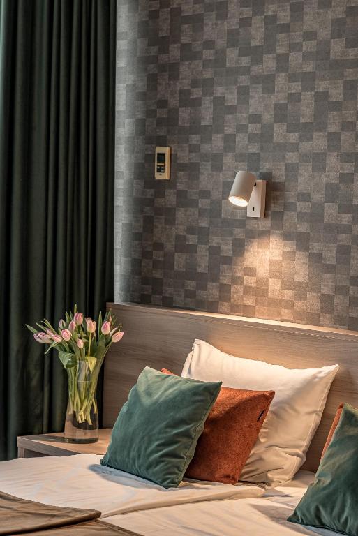 Postel nebo postele na pokoji v ubytování Hotel Zemaites
