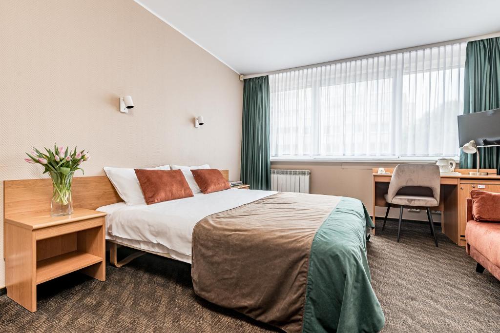 Postel nebo postele na pokoji v ubytování Hotel Zemaites