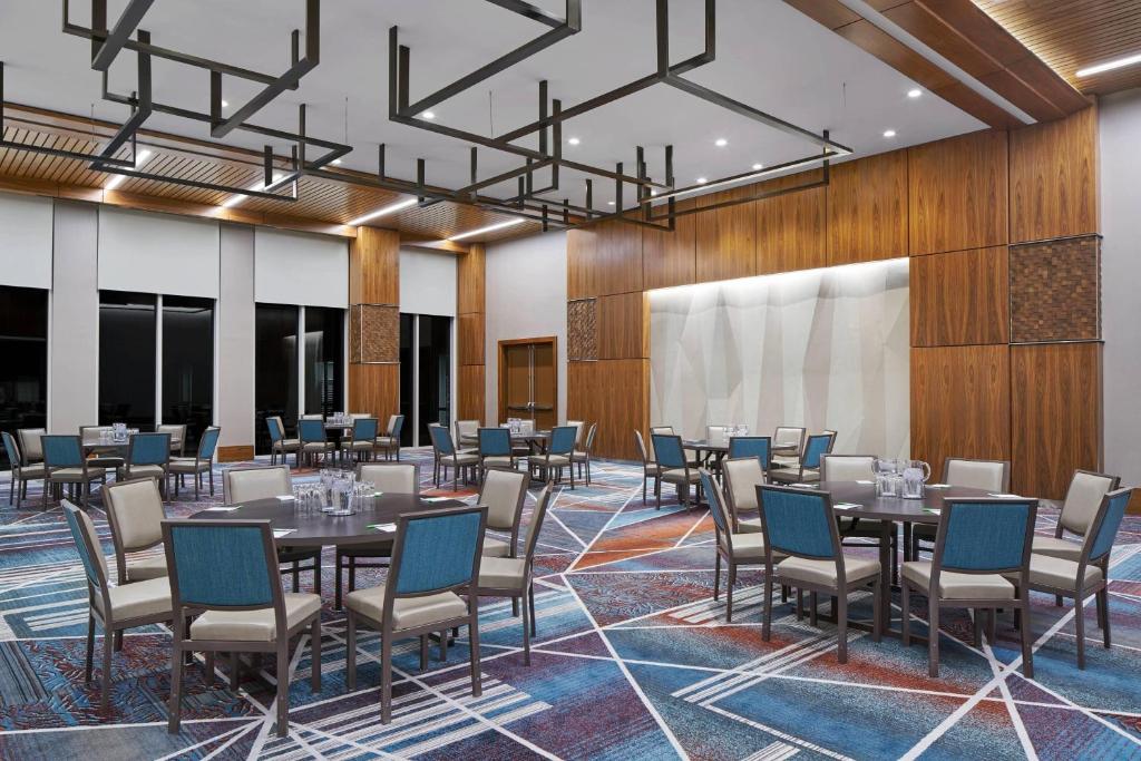 Conference room with round tables, chairs, and wood-paneled walls at Residence Inn Washington Downtown/Convention Center