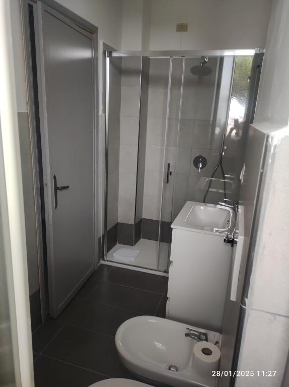 a bathroom with a shower and a toilet and a sink at Ostello Villa Monte Mario in Rome