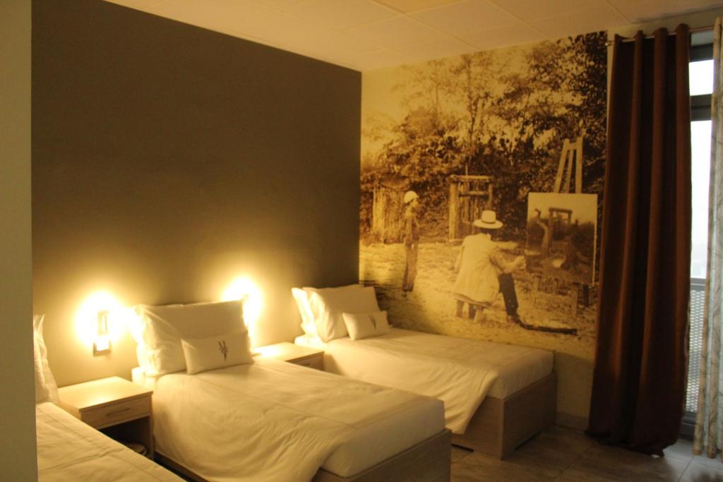 a room with two beds and a painting on the wall at Volpedo hostel in Volpedo