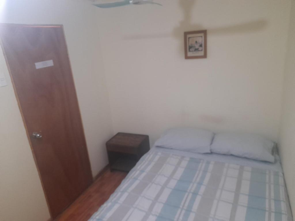 Postel nebo postele na pokoji v ubytování Nuevo Hostal Consulado