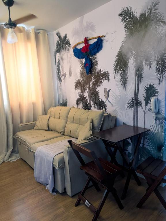 a living room with a couch and a table at Tropical apartament in São Paulo
