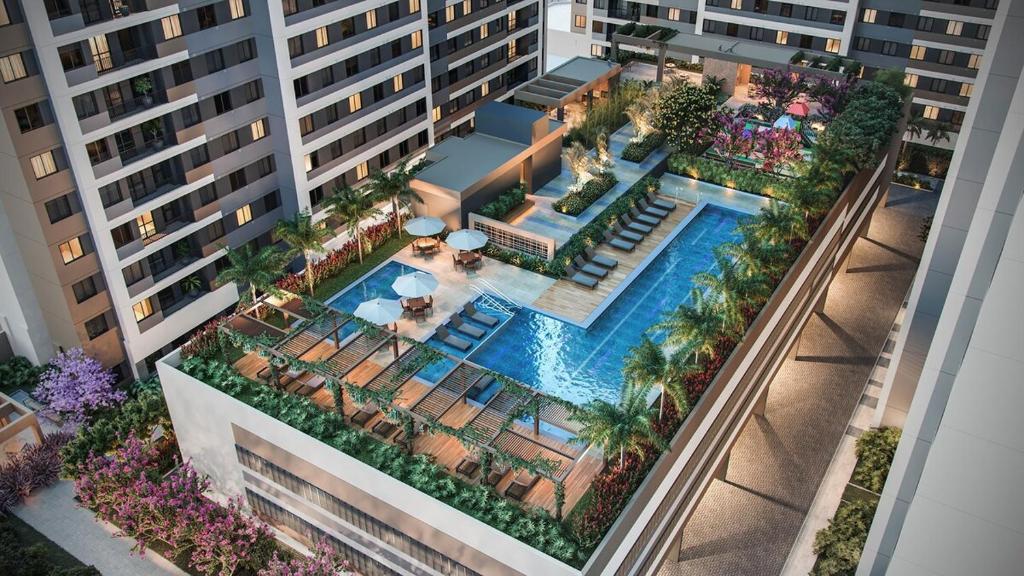an overhead view of a building with a swimming pool at Tropical apartament in Sao Paulo