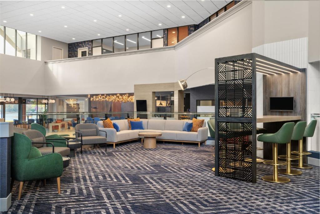 a lobby of a hotel with couches and chairs at Crowne Plaza Virginia Beach Town Center by IHG in Virginia Beach