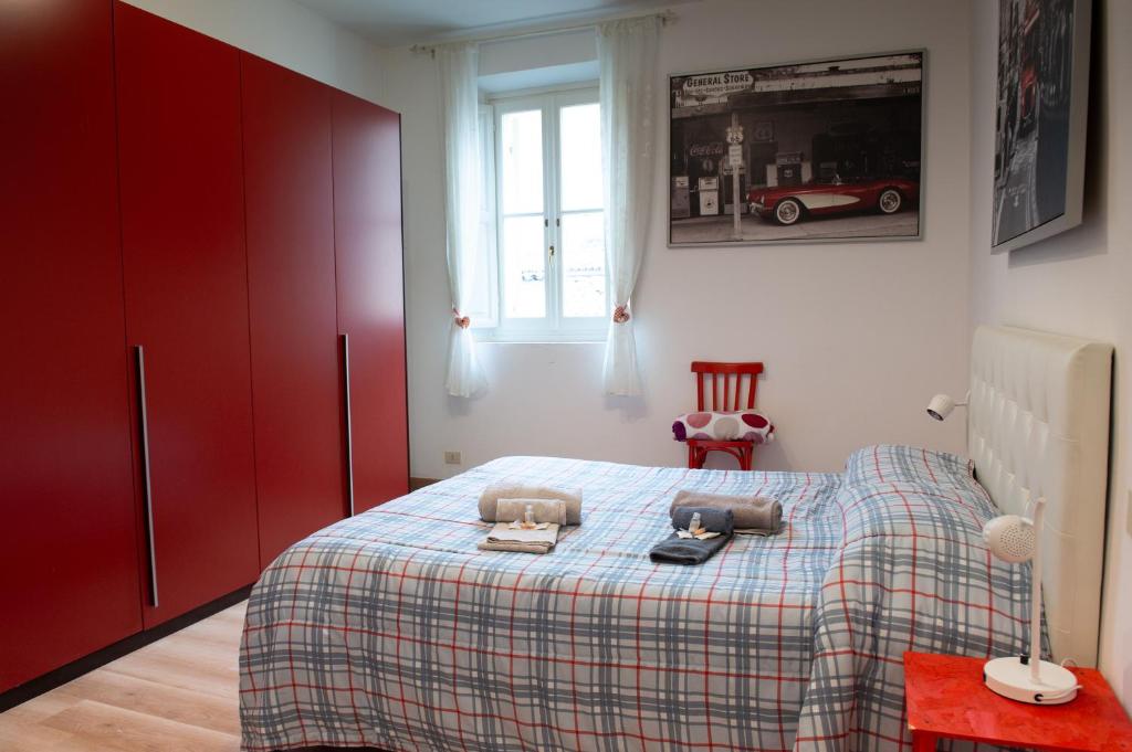 a bedroom with a bed with a plaid blanket at Historic center Teatro Regio appartamento Luca in Parma