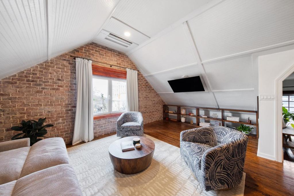 a living room with a couch and a table at The Hidden Hideaway on College in Macon