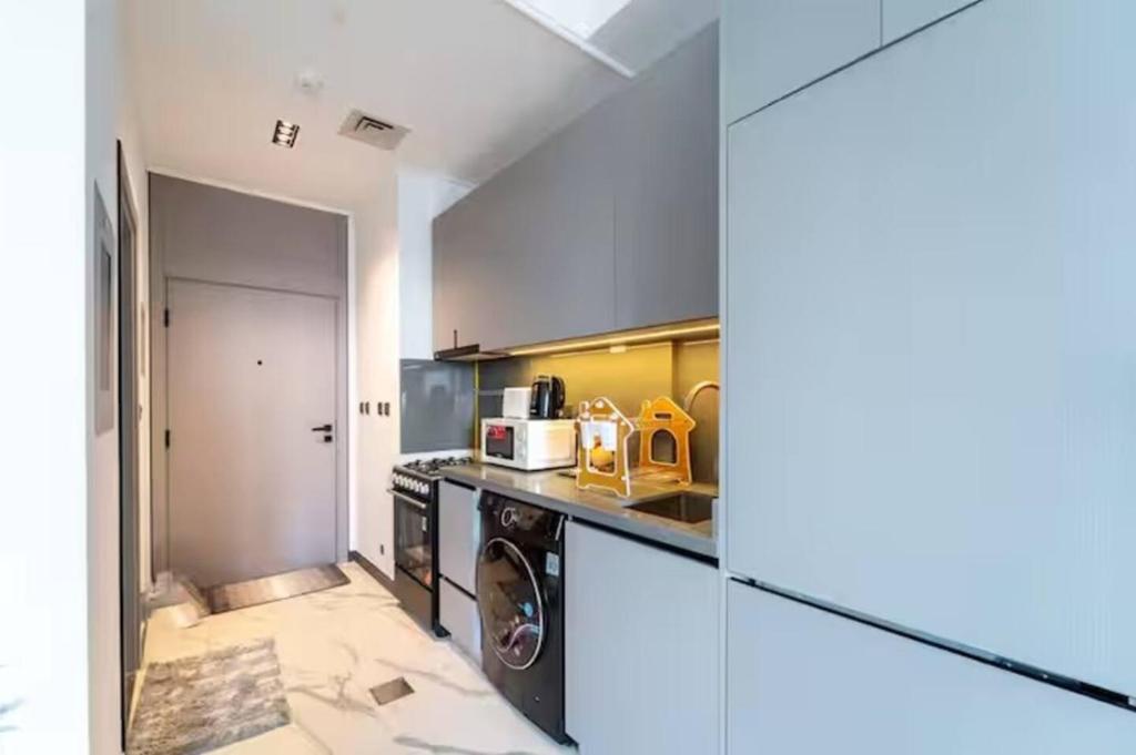 a kitchen with a stove and a washer and dryer at 017 - Mag 900 in Umm Al Quwain