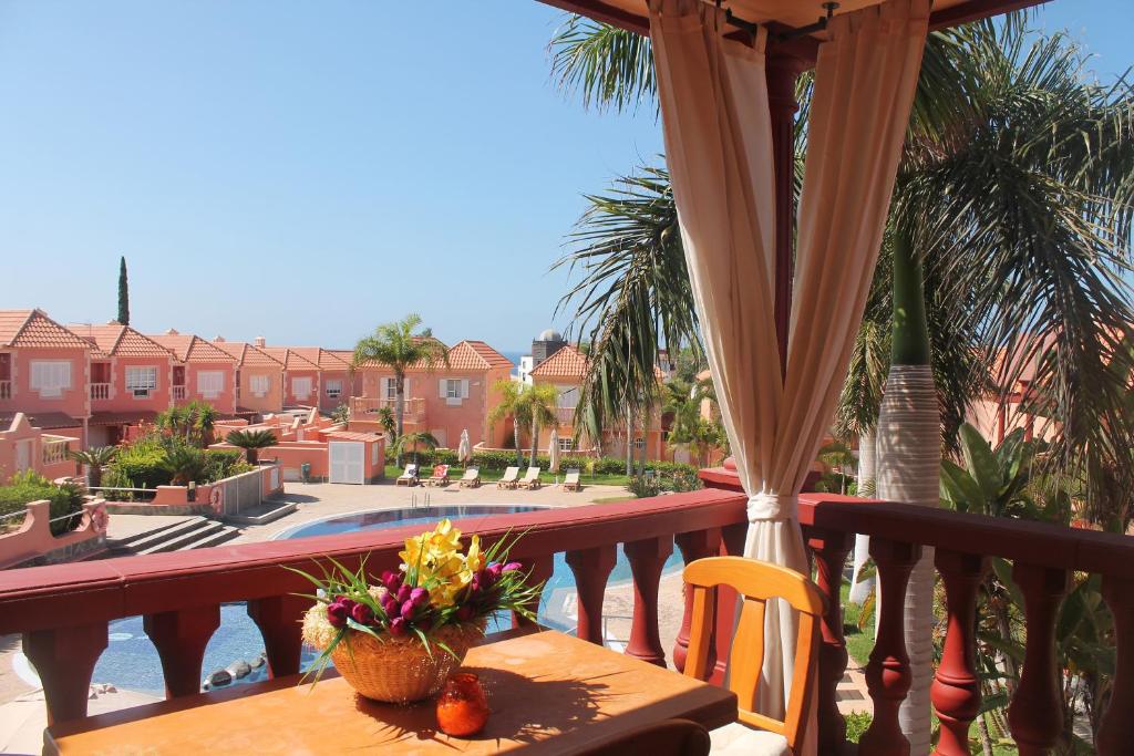 a balcony with a table and a view of a pool at Nice apartment Duque Tenerife South in Adeje