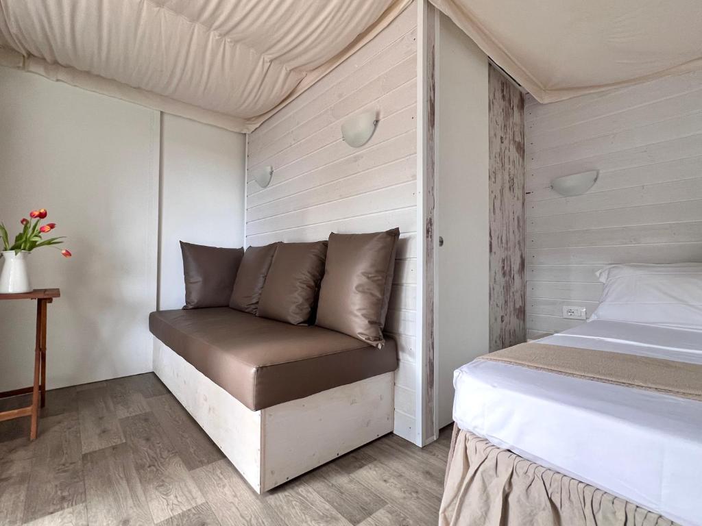 A bed or beds in a room at Camping Campo dei Fiori