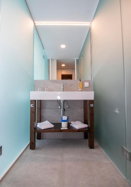 a bathroom with a sink and a mirror at Hotel Euro Moniz in Porto Moniz