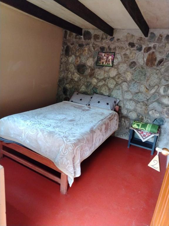 Postel nebo postele na pokoji v ubytování HOSTEL SAMANA WASI CHAULLAY