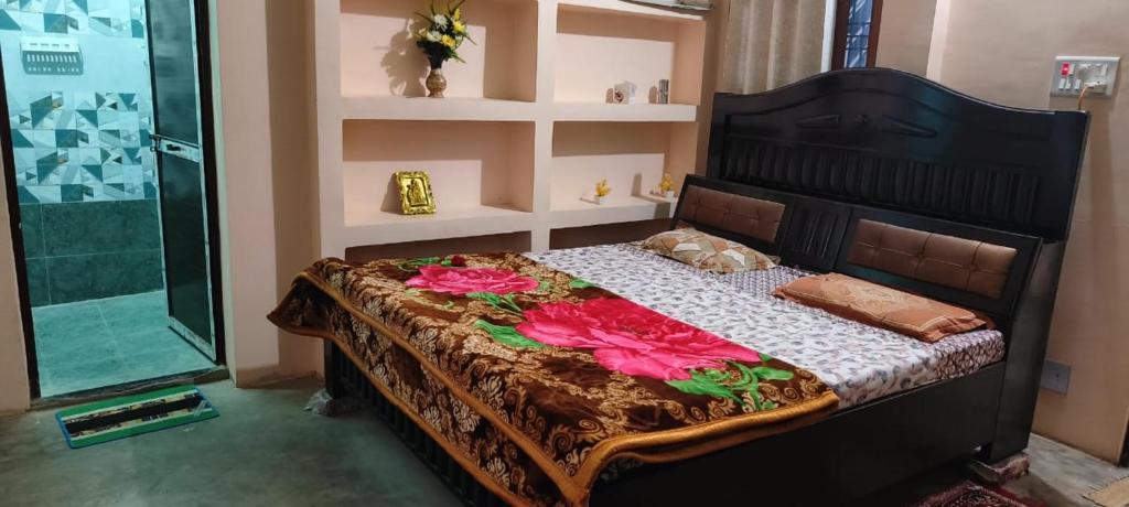 a bedroom with a bed with flowers on it at Triveni Neo Home Stay in Prayagraj
