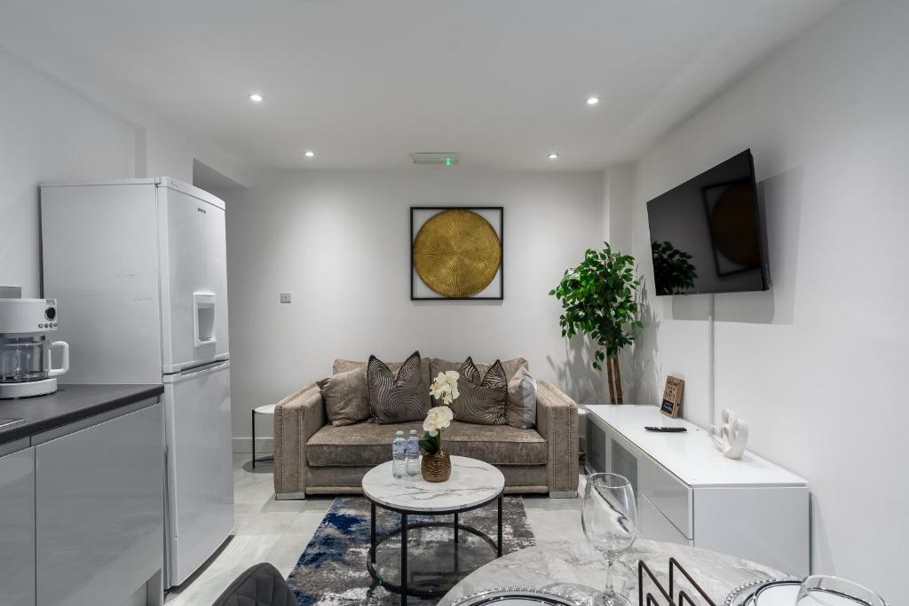 a living room with a couch and a table at Avalon luxury stays in Strood
