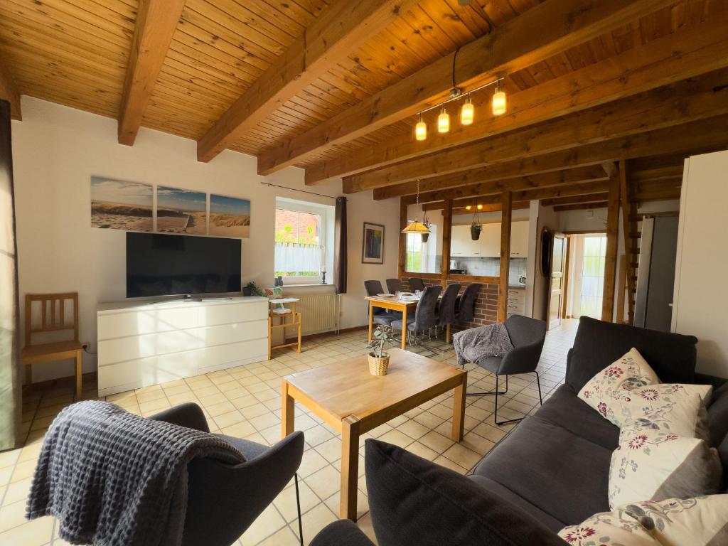 a living room with a couch and a table at Tegeler Plate 26 in Wangerland