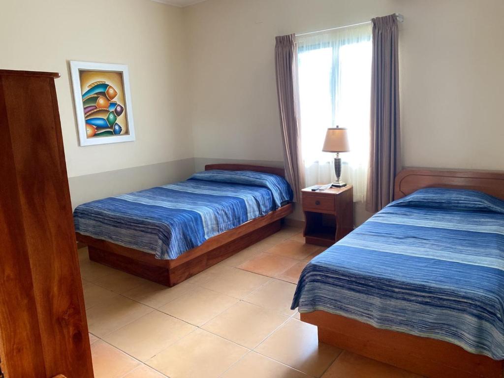 Postel nebo postele na pokoji v ubytování Hotel Playa Bonita Tela