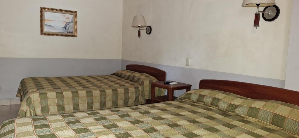 Postel nebo postele na pokoji v ubytování Hotel Playa Bonita Tela