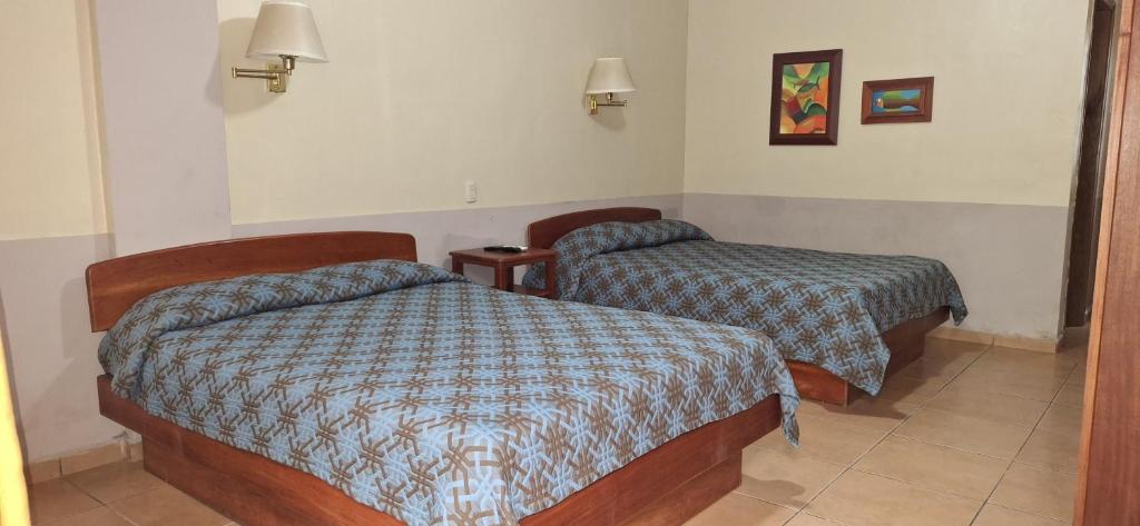 Postel nebo postele na pokoji v ubytování Hotel Playa Bonita Tela