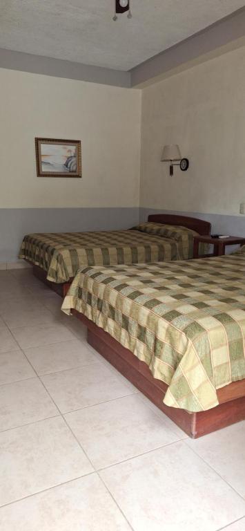 Postel nebo postele na pokoji v ubytování Hotel Playa Bonita Tela