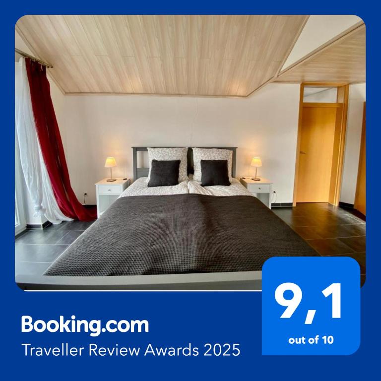 a bedroom with a large bed with two night stands at Moderne Ferienwohnung Seeblick in Freudenberg