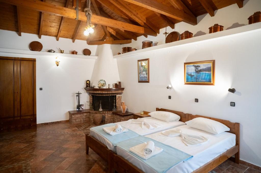 a bedroom with a bed and a fireplace at Giannakos Apartments in Ydroússa