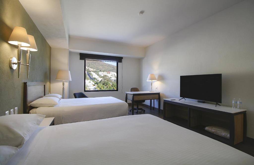 Postel nebo postele na pokoji v ubytování Hotel Turotel Morelia