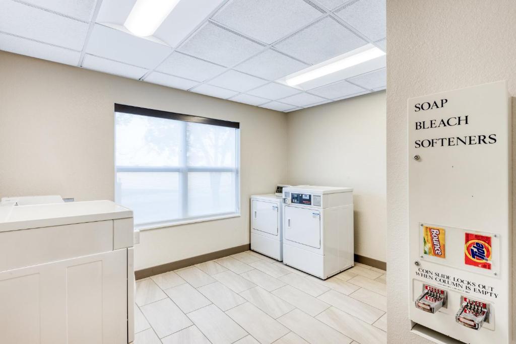 a laundry room with a washer and dryer and a window at Holiday Inn Express & Suites - Green Bay East by IHG in Green Bay