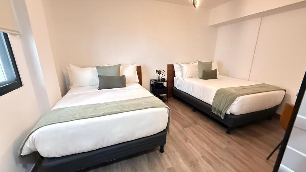 Postel nebo postele na pokoji v ubytování ESHEL SUITES PANAMA