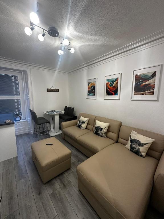 a living room with a couch and a table at Stonehaven Centre - Dunnottar Apartment in Stonehaven